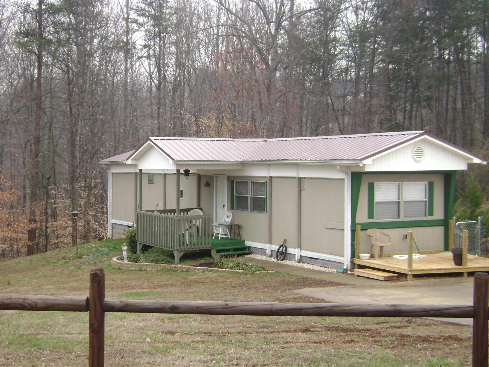 Mauve metal roof on a manufactured home with a new front deck in Prattville